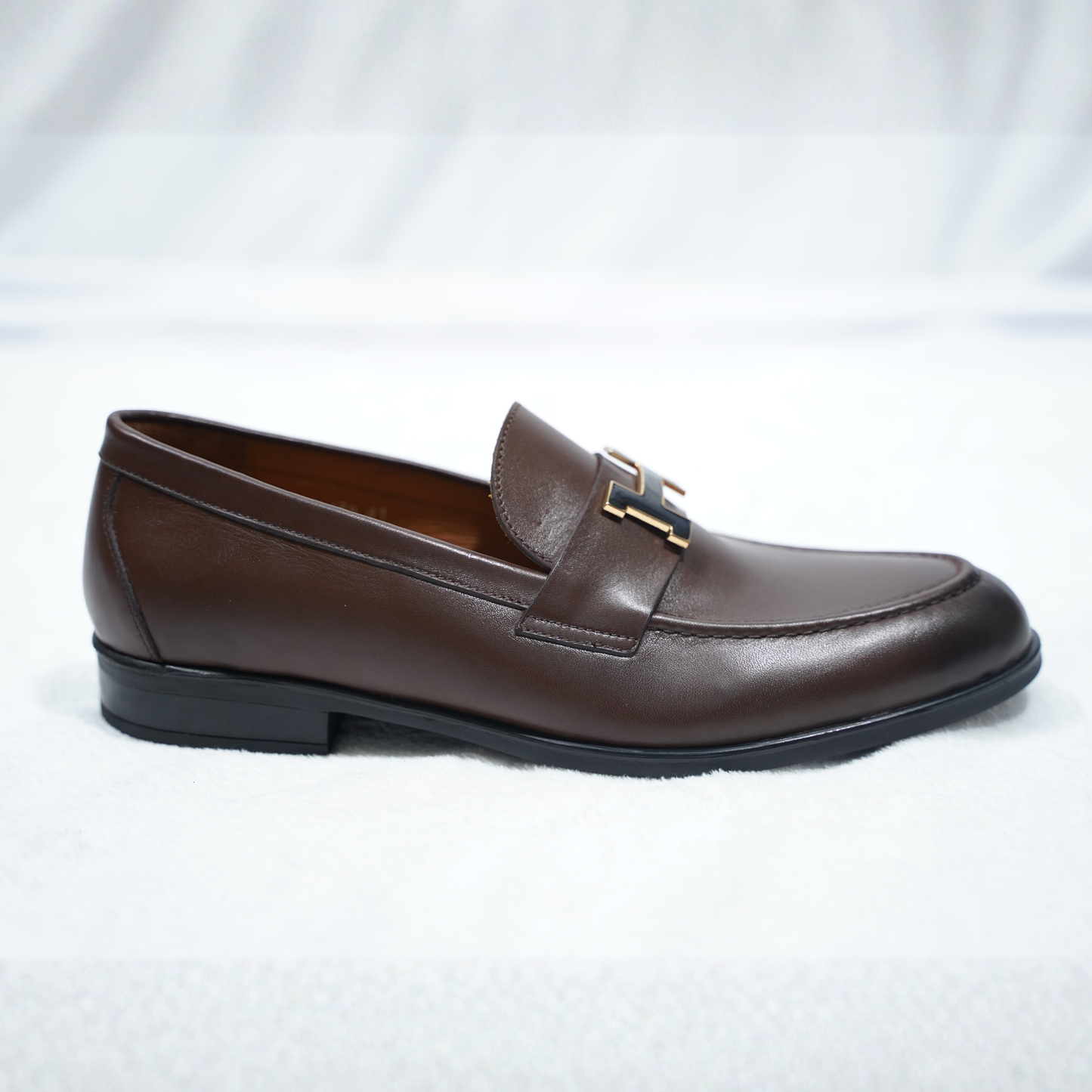 Mocassin en peau de chèvre patinée avec boucle iconique "Paris", pour un look chic.